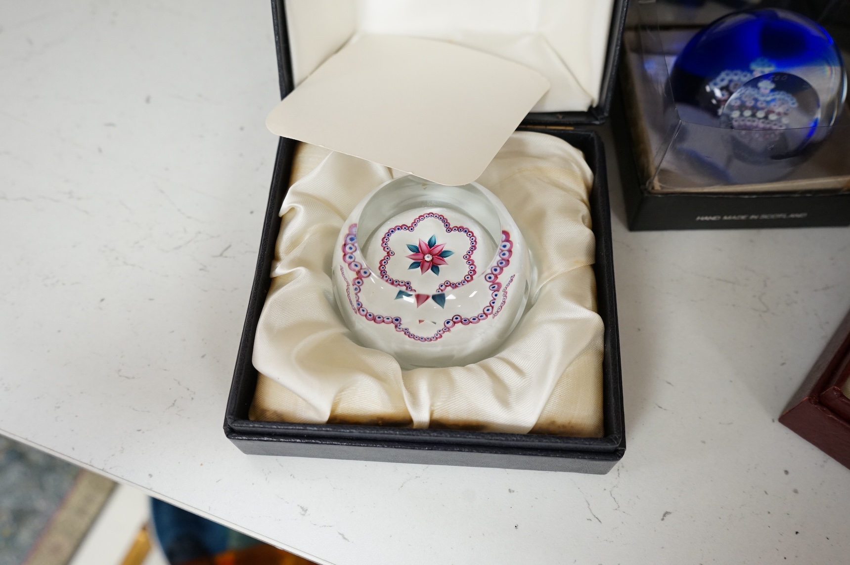 A group of five Caithness limited edition glass paperweights; highland fling, 01/250, Partridge in a pear tree, 56/500, Millefiori crown, 221/500, Rona, 56/500, Royal Birthday crown, 118/250 together with a moon crystal